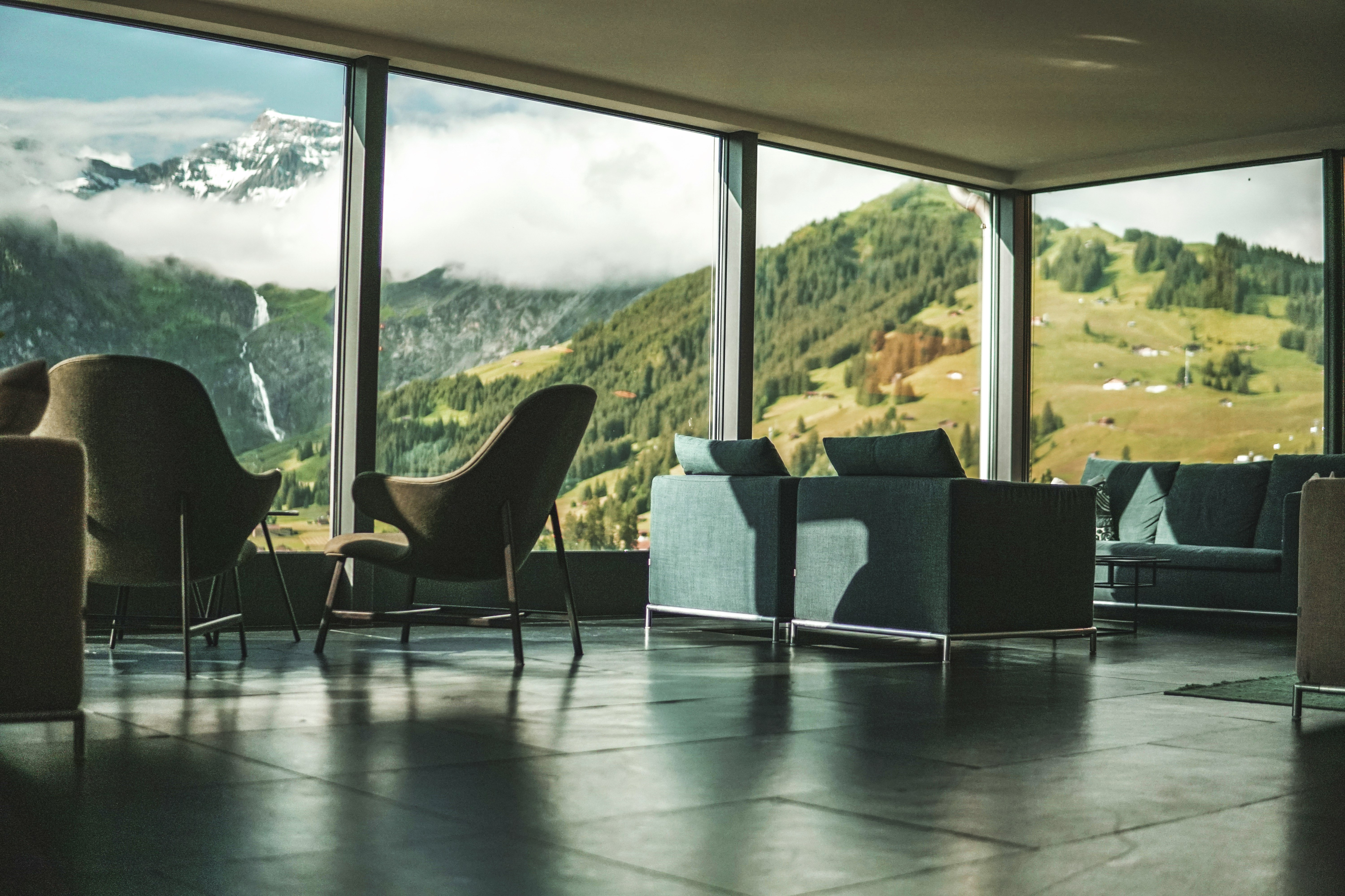 black and white padded chair near glass window